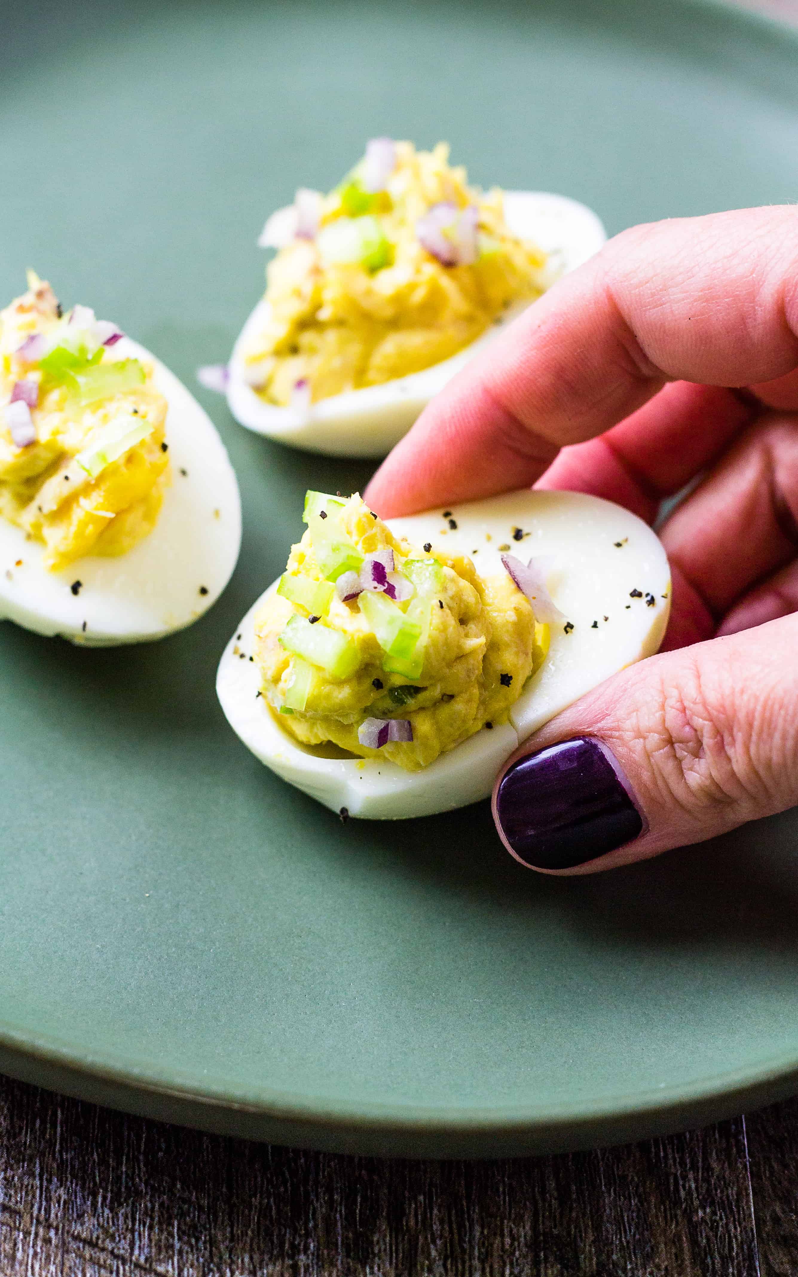 close up of picking up tuna deviled eggs