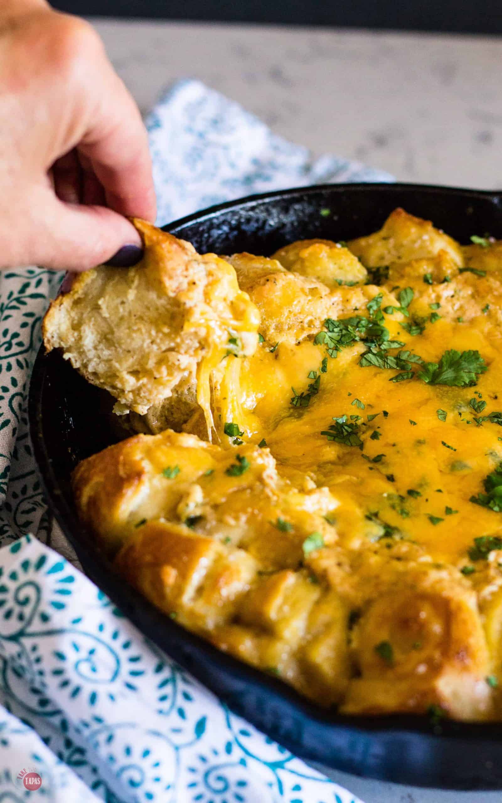 Mexican Beer Cheese Skillet Dip with Shortcut Soft Pretzel being pulled off
