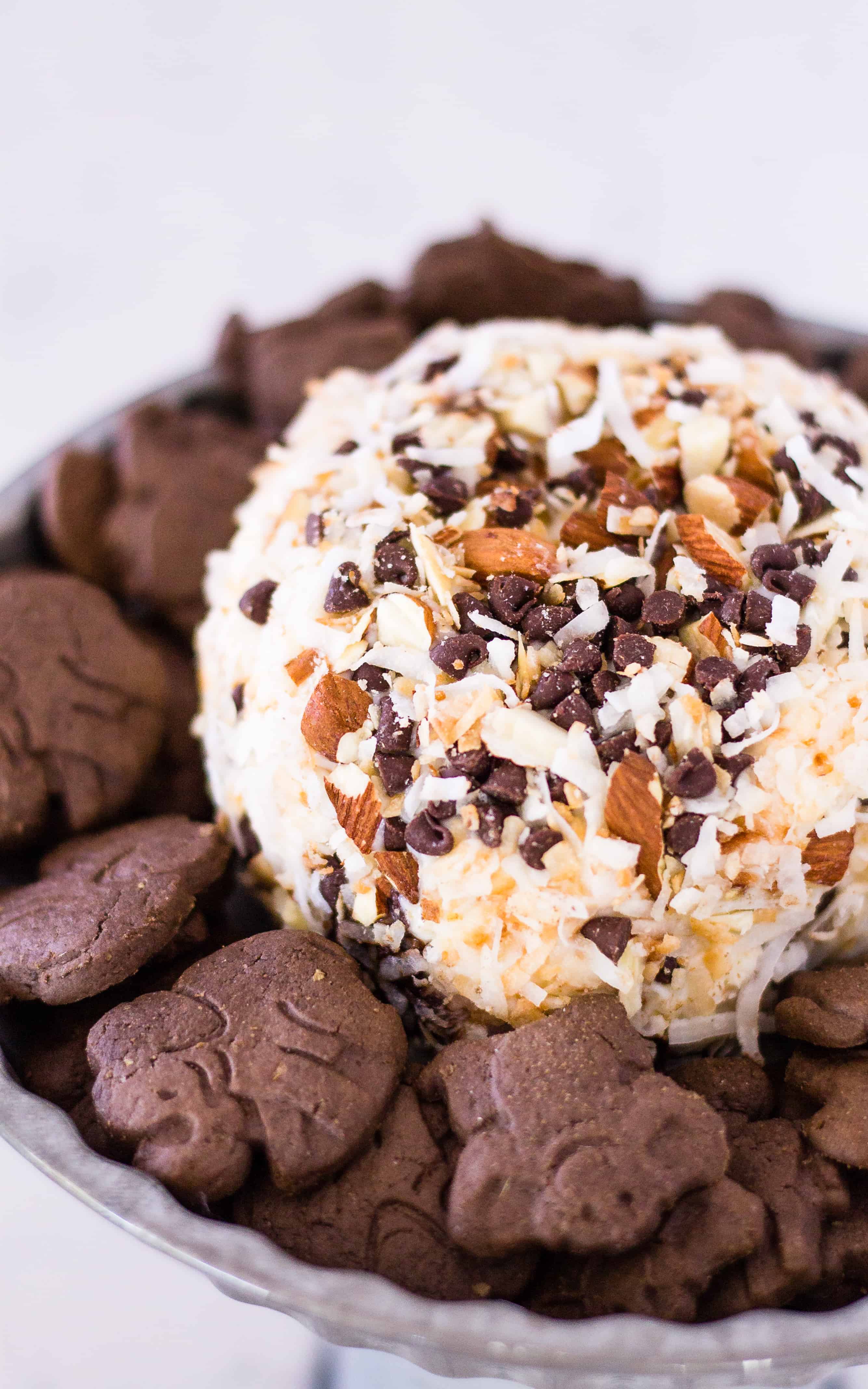 Almond Joy Cheese ball on a platter surrounded by chocolate cookies