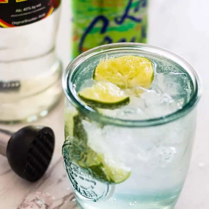 Jalapeño Caipirinha Cocktail with bottle and can of La Croix in background