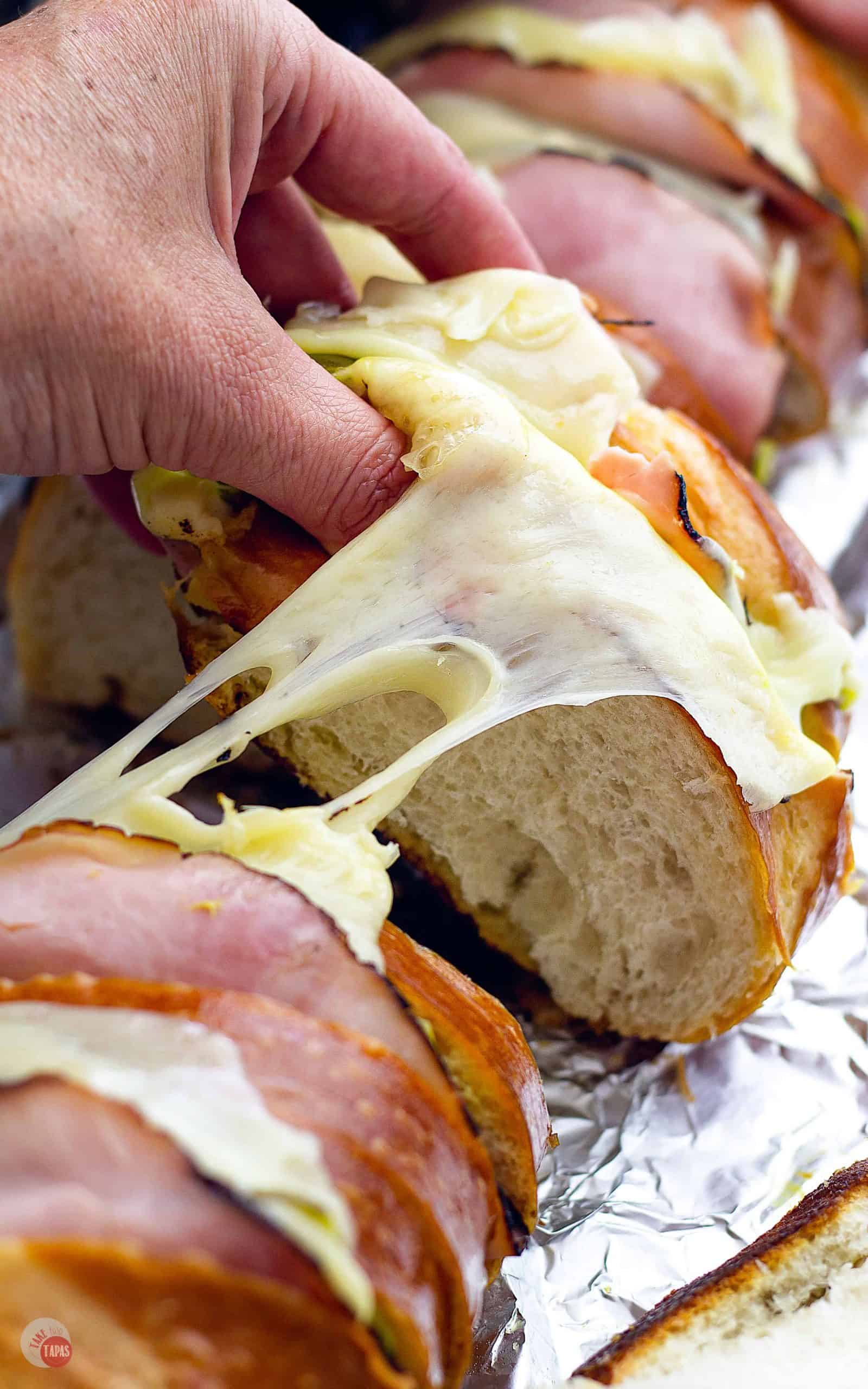 A whole Cuban Sandwich Loaf for a Crowd - Tailgating Sandwiches | Take Two Tapas | #TailgatingSandwiches #GrillRecipes #LargeSandwiches #CubanSandwich #CubanSandwichLoaf #GrillSandwiches #MakeAheadTailgateRecipes