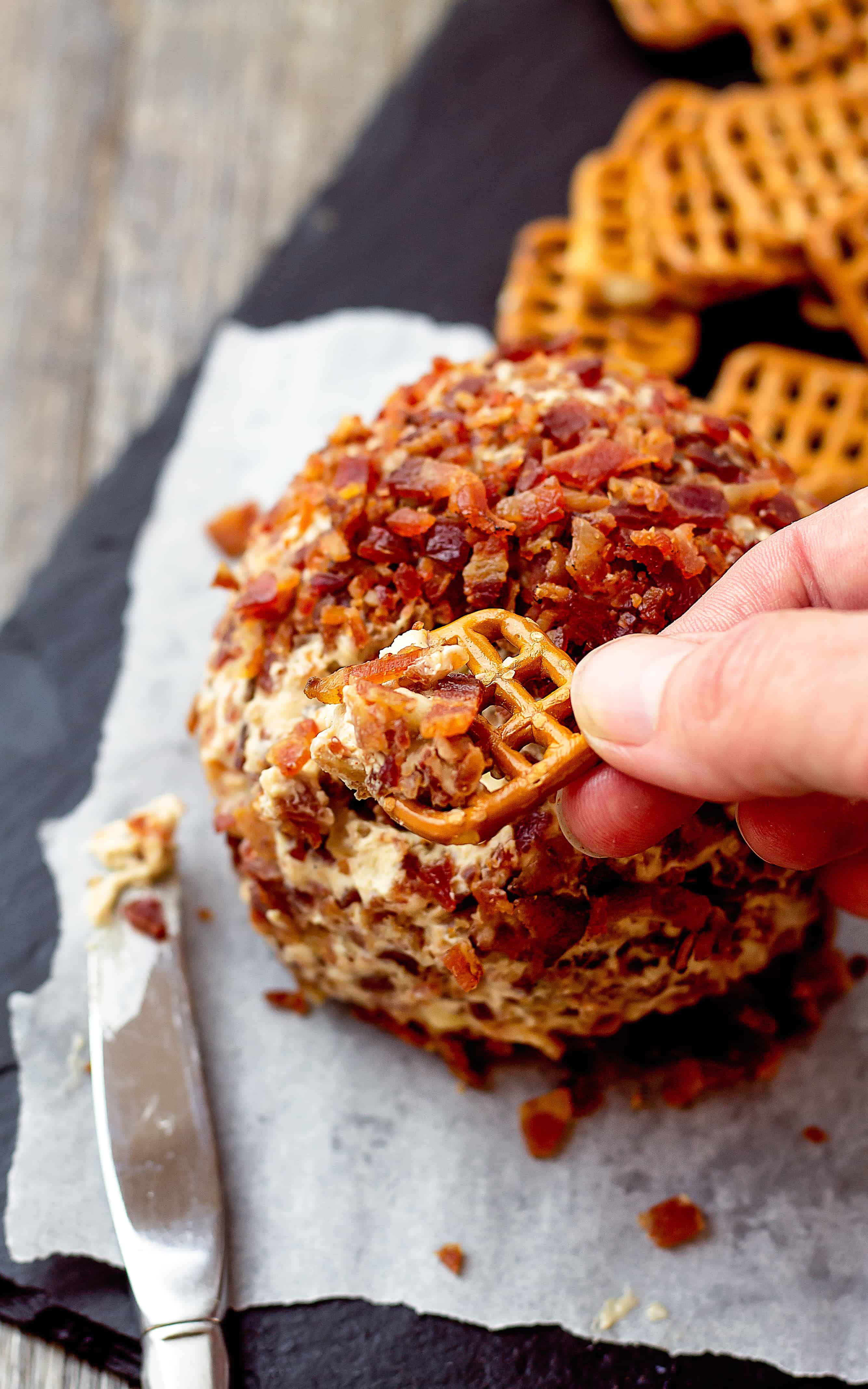 Use a wide pretzel or cracker to serve this Elvis Cheese Ball - Peanut Butter Banana Bacon Cream Cheese Ball | Take Two Tapas | #ElvisRecipe #BananaRecipe #BaconRecipe #PeanutButterBacon #PeanutButterBanana