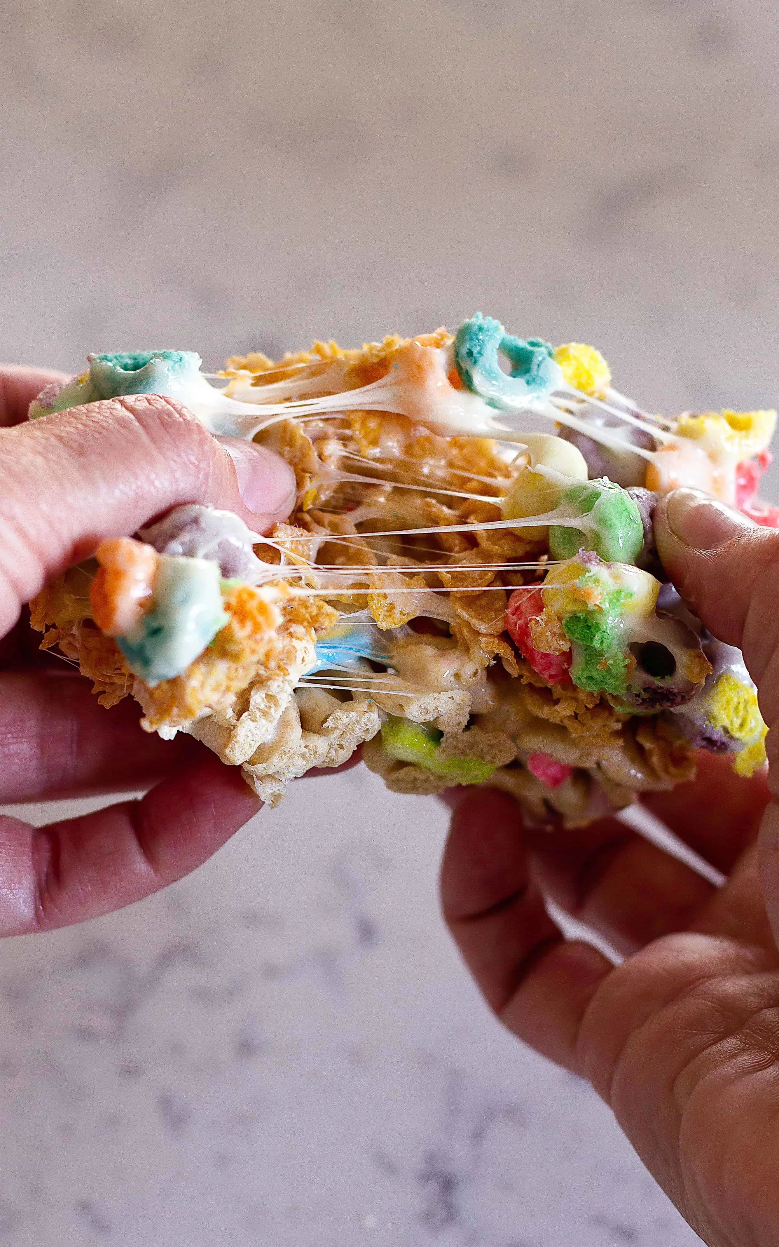 Hands pulling a cereal bar apart