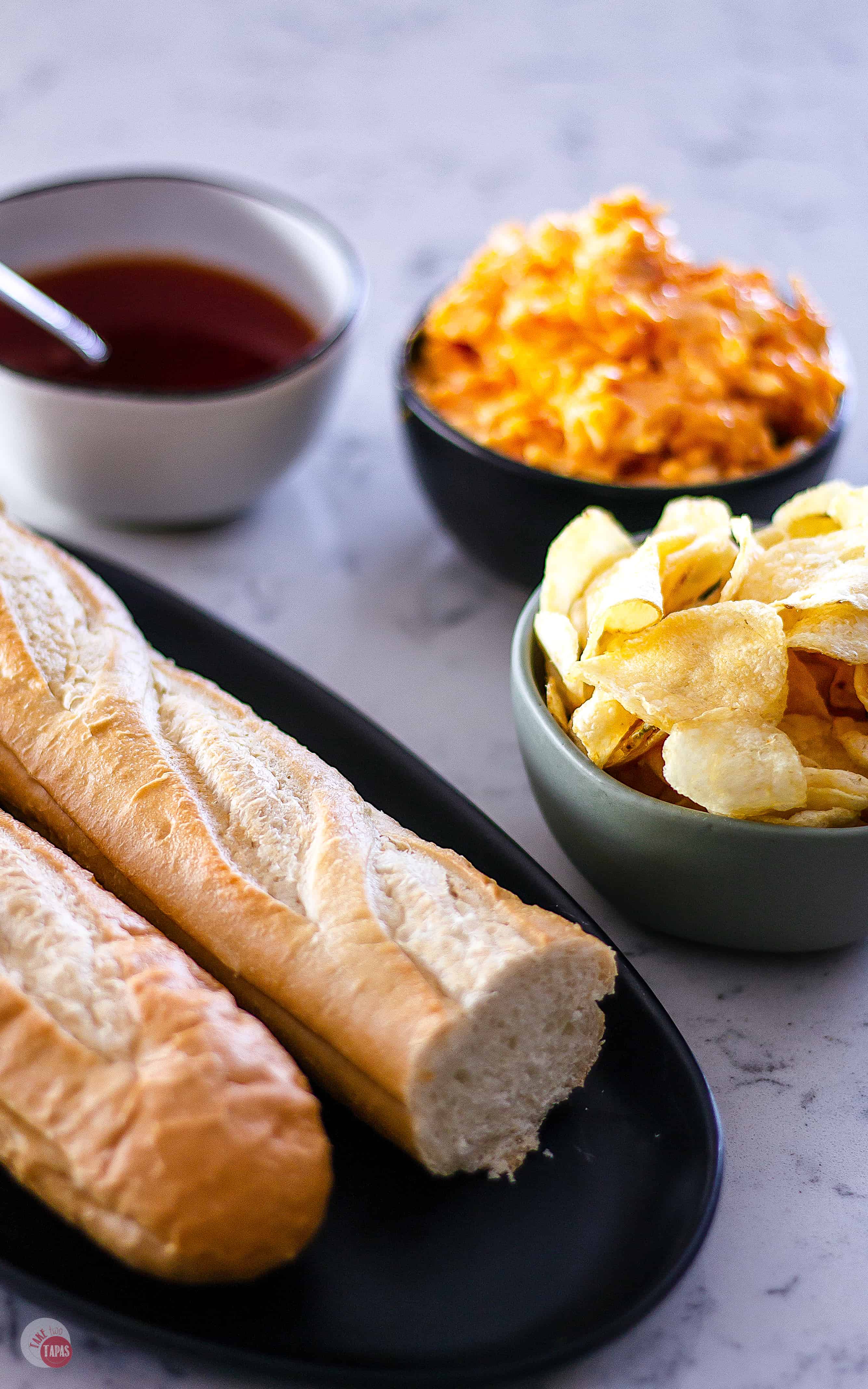 Need an easy appetizer for a crowd? Sweet and Spicy Pimento Cheese Bread Recipe | Take Two Tapas | #PimentoCheese #BreadAppetizer #FrenchBread #PartyFoods #PepperJelly #SemiHomemade