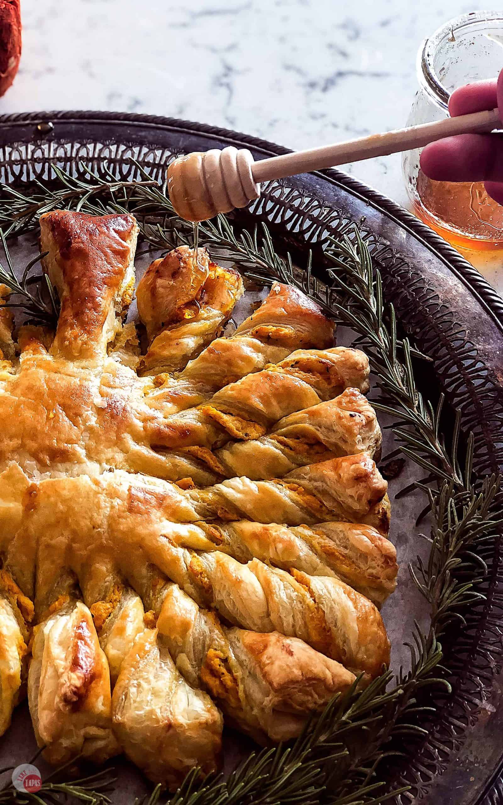 Honey being drizzled on Easy Golden Brown and Flaky Pumpkin Pull Apart Puff Pastry