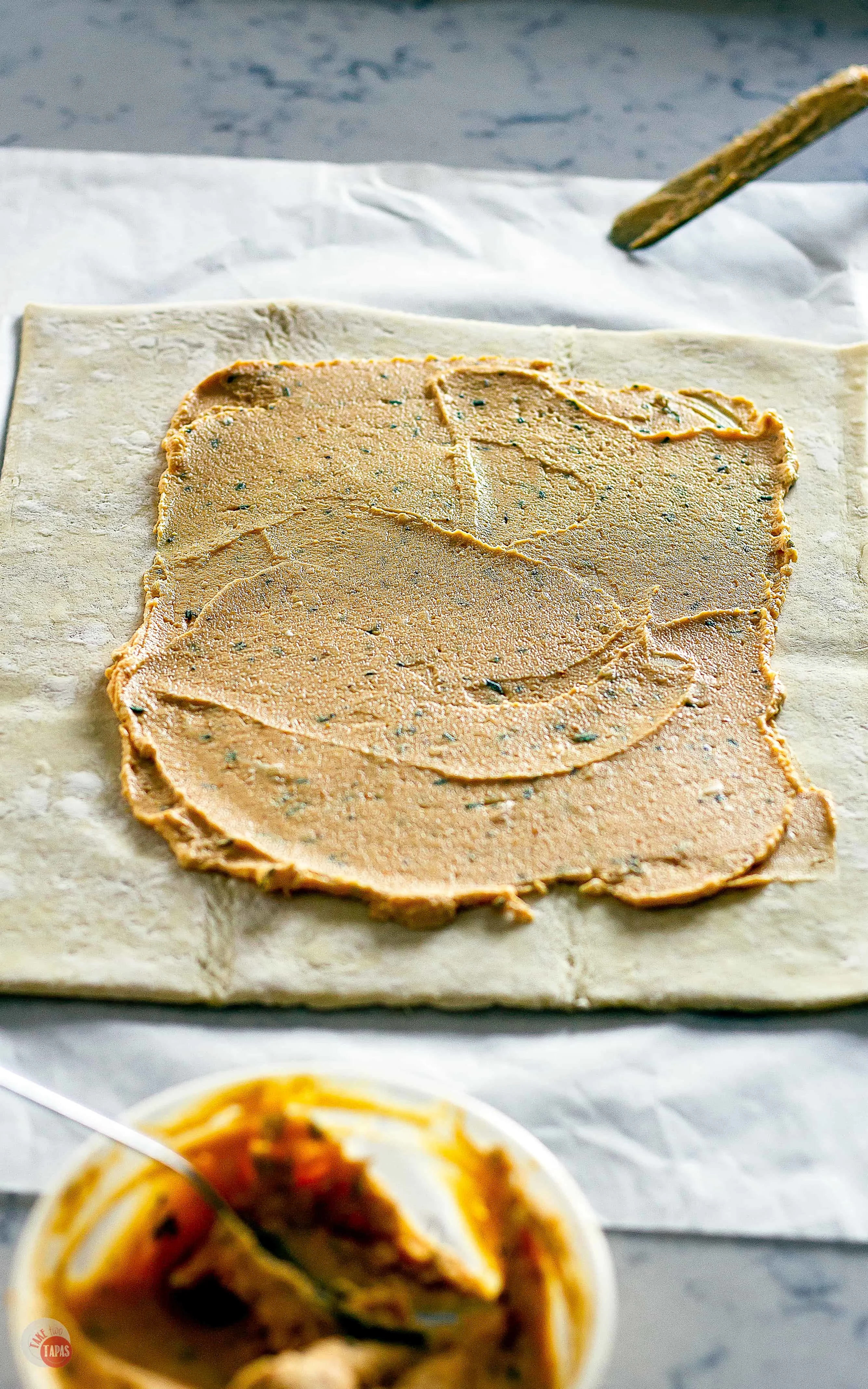 A roasted garlic and goat cheese spread in my Easy Pumpkin Pull Apart Puff Pastry | Take Two Tapas | #PuffPastryRecipe #PumpkinRecipe #PullApartBread #FallRecipe #AppetizerRecipe #HolidayFoods #EasyHolidayRecipe