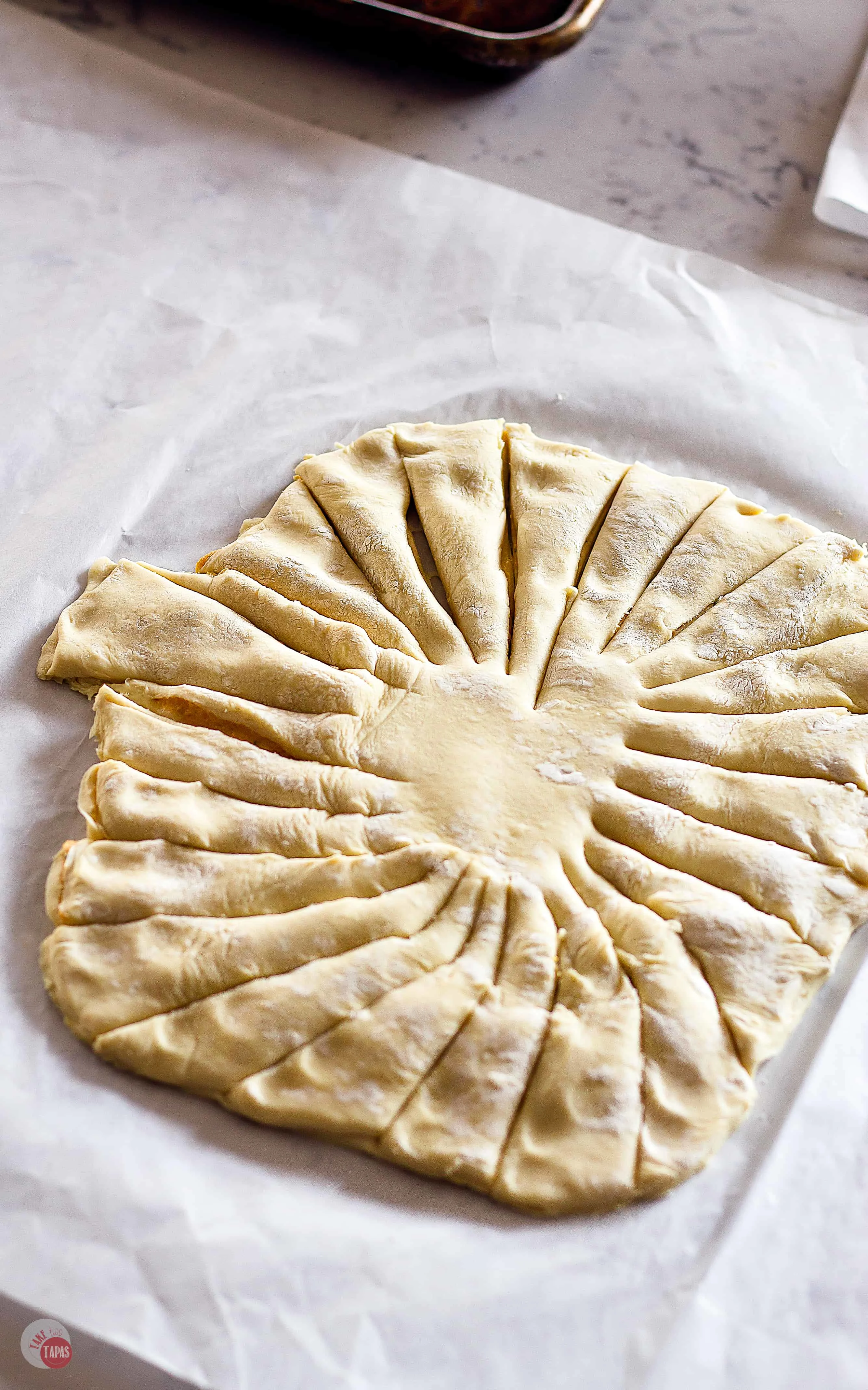 Trim to a pumpkin shape and cut into strips | Easy Pumpkin Pull Apart Puff Pastry | Take Two Tapas | #PuffPastryRecipe #PumpkinRecipe #PullApartBread #FallRecipe #AppetizerRecipe #HolidayFoods #EasyHolidayRecipe