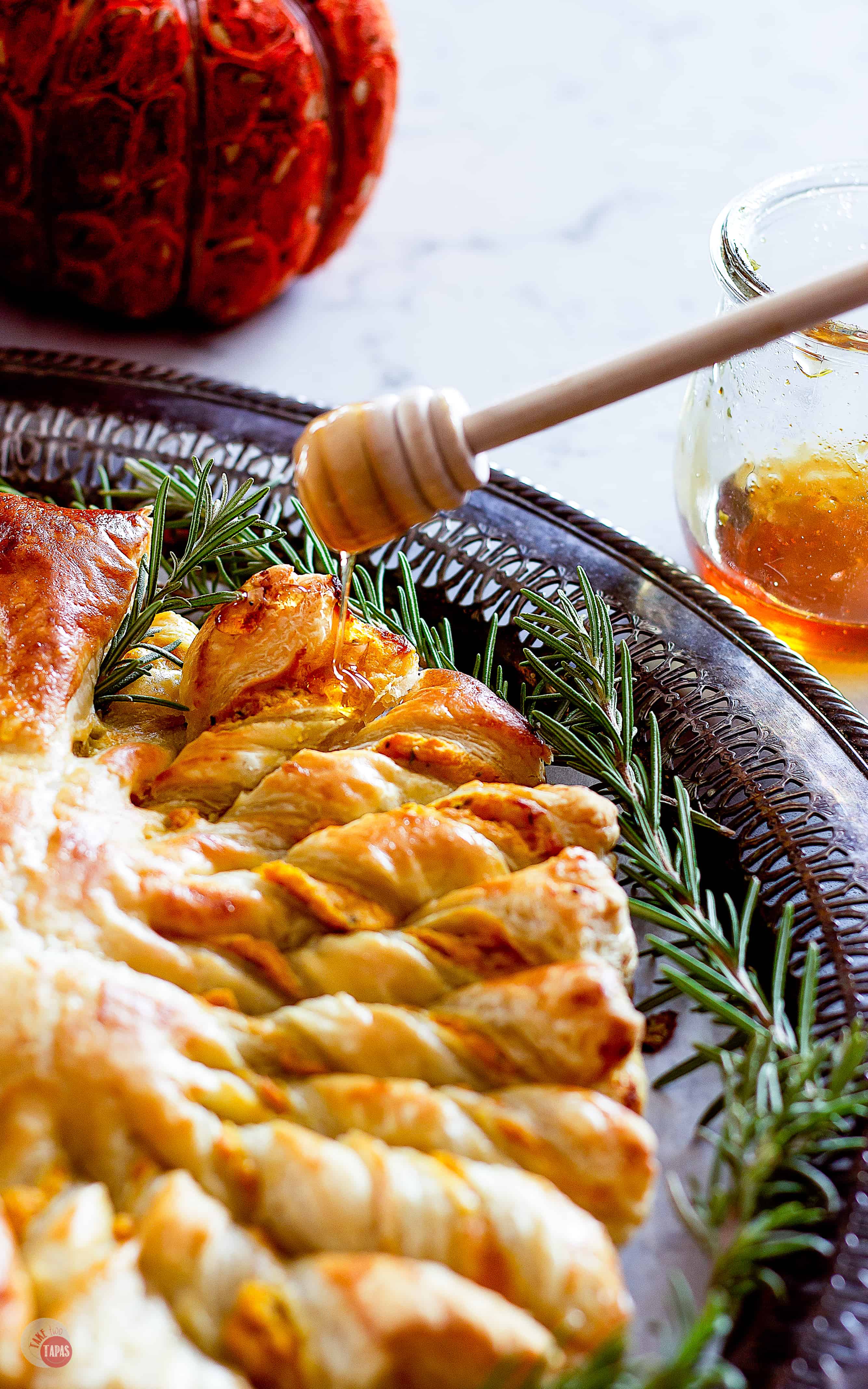 Drizzling honey on party of the pull apart puff pastry