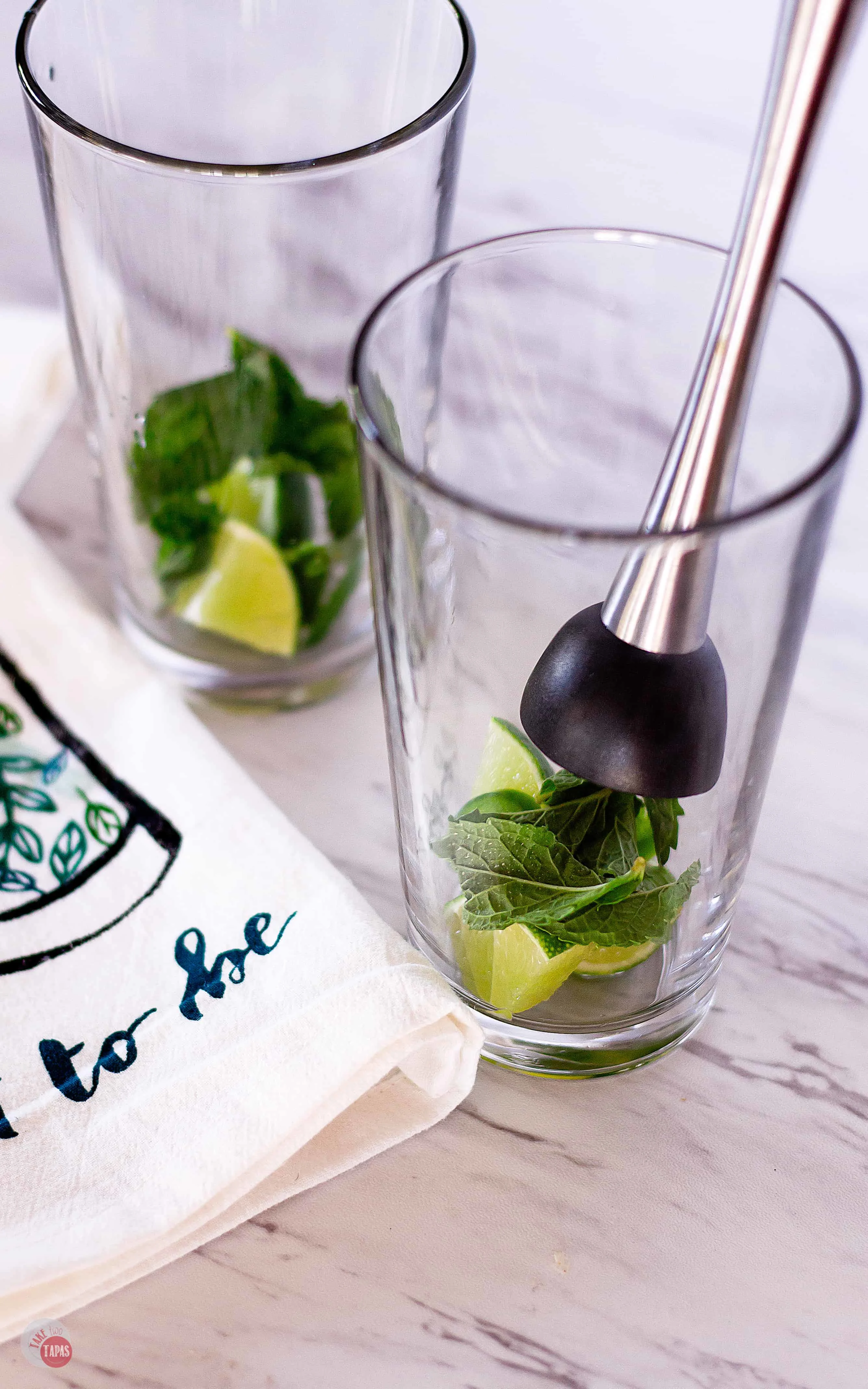 Muddle some mint and lime for this Spicy Jalapeño Mojito Recipe | Take Two Tapas | #MojitoRecipe #RumCocktail #Mint #JalapeñoRecipe #CocktailRecipes