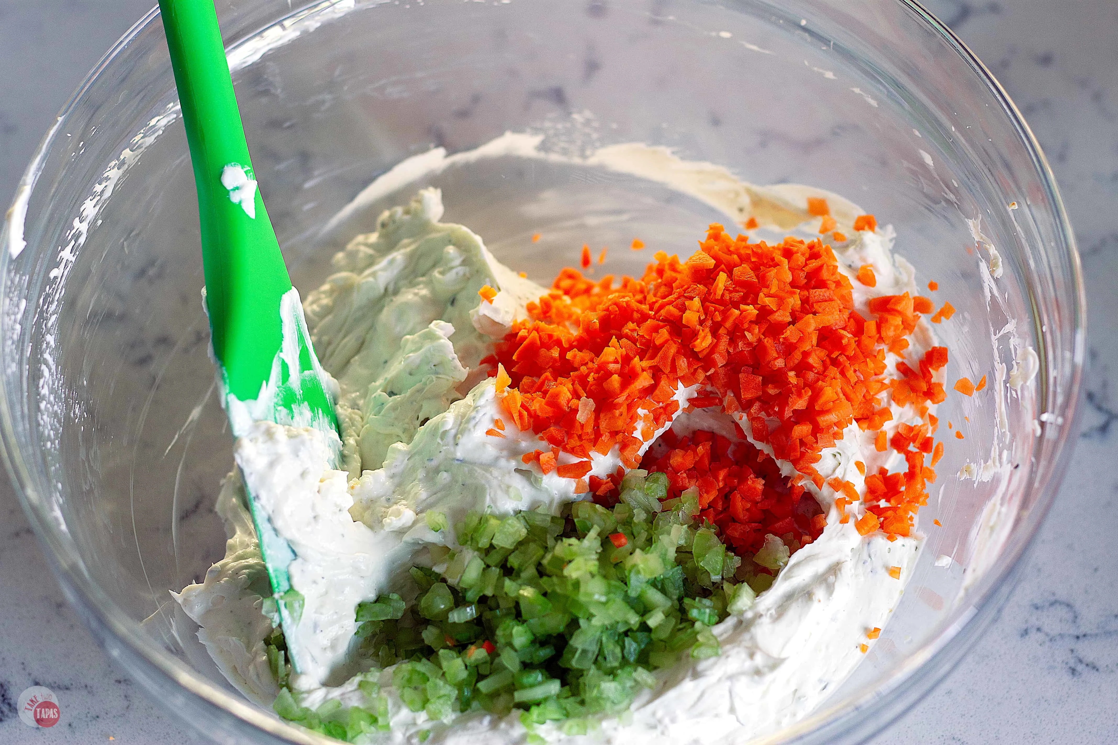 When the chicken wing dip debate rages on, come together over this Blue Ranch Chicken Wing Dip that is a combination of the two most popular dips. Complete with a sprinkling of carrots AND celery! | Take Two Tapas | #ChickenWingDip #BlueCheeseRecipe #RanchDressingRecipe #Tailgating