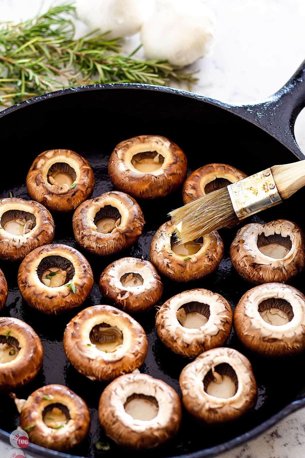 pan of mushrooms with a brush