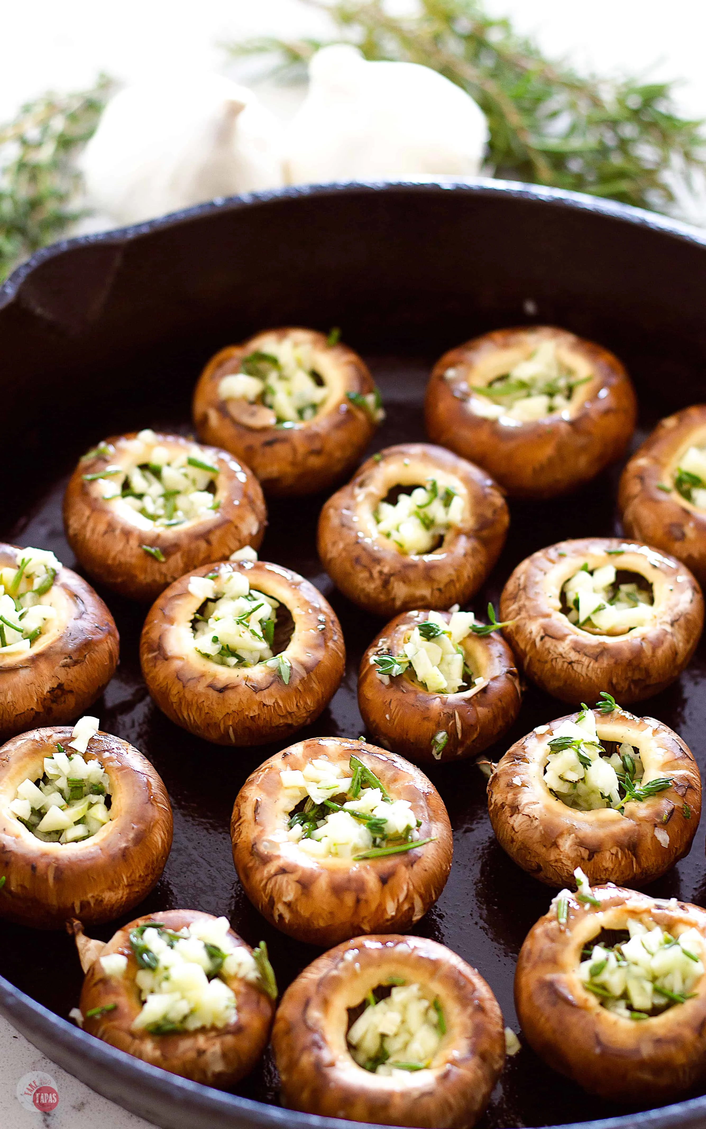 Fill the mushroom caps with all the garlic and herbs! Roasted Garlic Butter Mushrooms | Take Two Tapas | #RoastedMushrooms #GarlicButter #GarlicMushrooms #MushroomRecipes