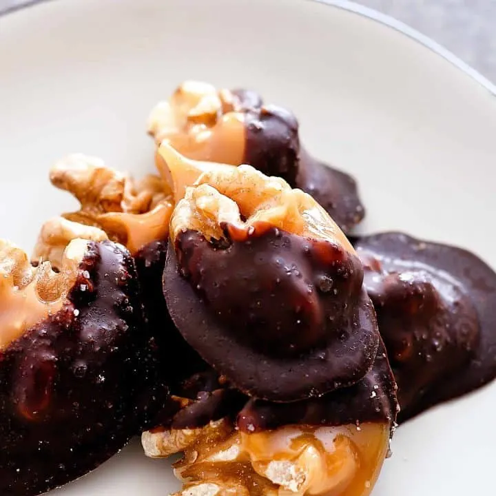 close up picture of Individual Salted Dark Chocolate Walnut Amaretto Turtles on a white plate
