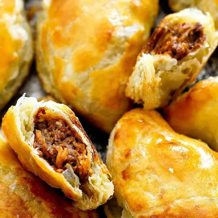 Close up of inside of empanada with other empanadas around it