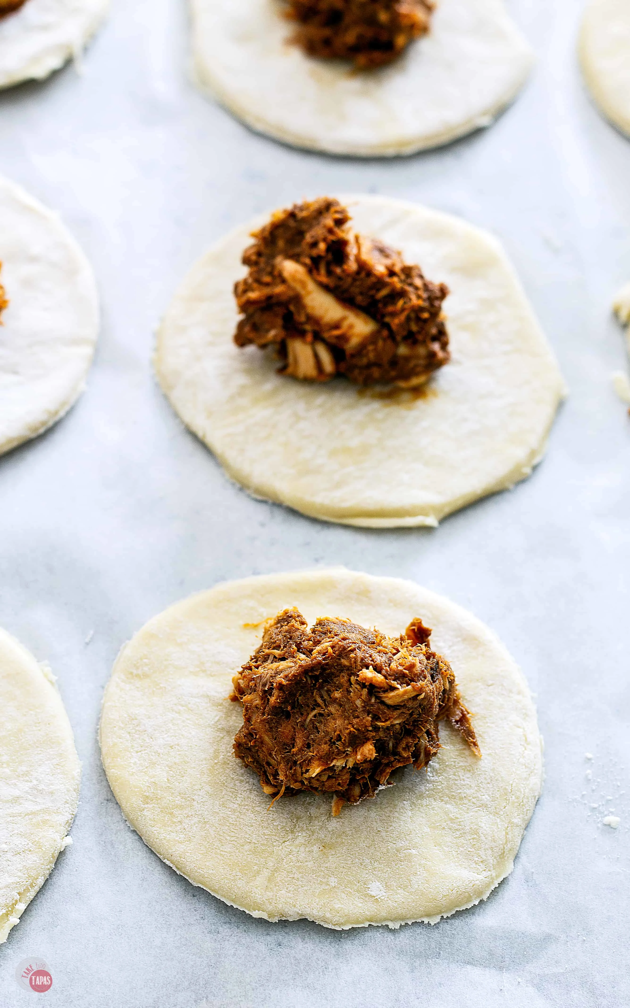 These dark chocolate mole empanadas are full of rich mole sauce and chicken, baked in a fluffy puff pastry shell, and are the perfect appetizer or meal | Take Two Tapas | #MoleRecipe #Empanadas #ad @fortechocolates