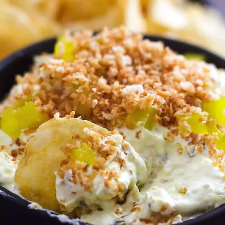 Side view of Fried pickle dip in a bowl