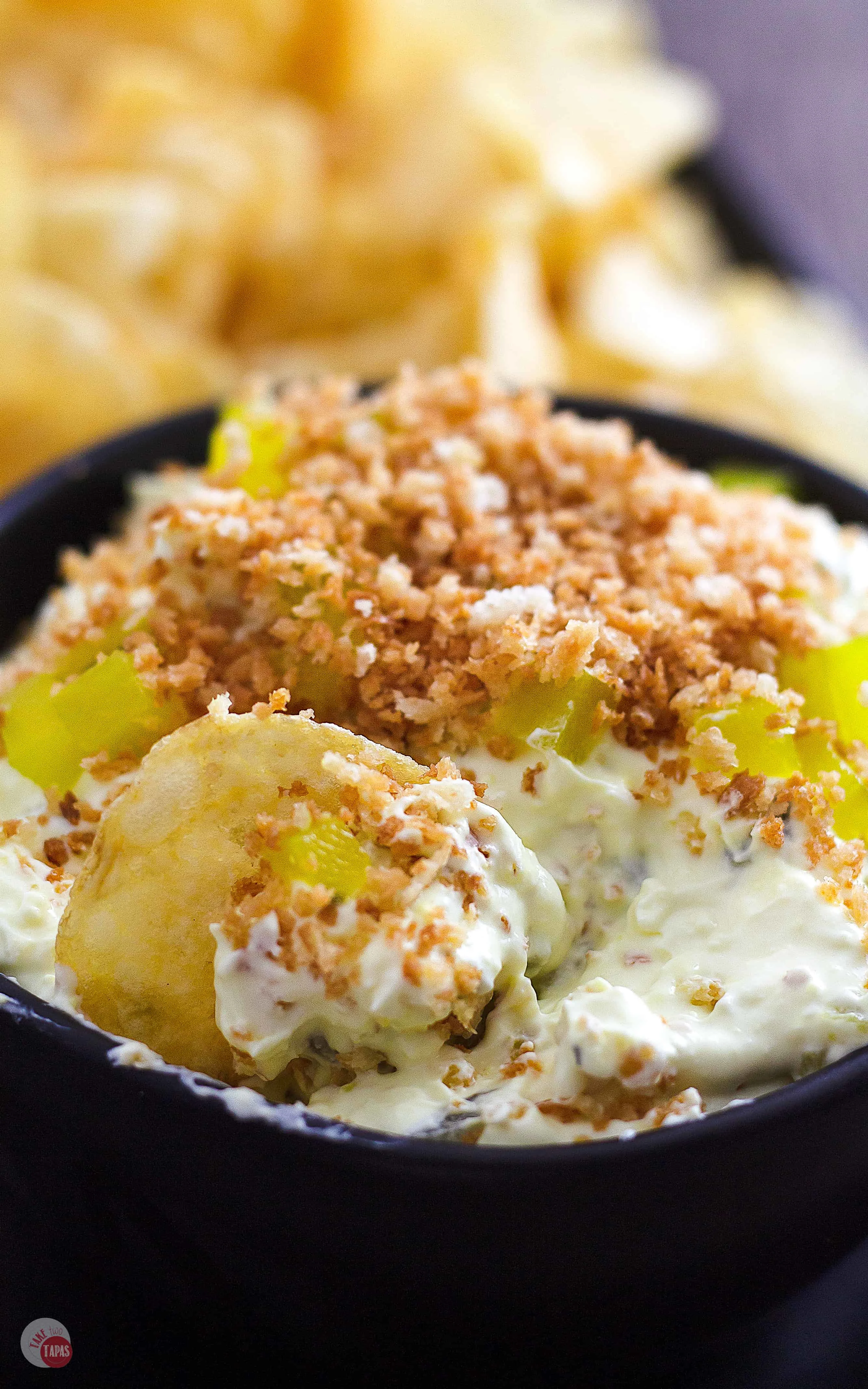 Side view of Fried pickle dip in a bowl