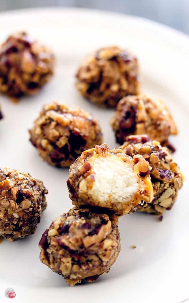 close up of Chewy nougat, covered in creamy caramel, and rolled in buttery toasted pecans.
