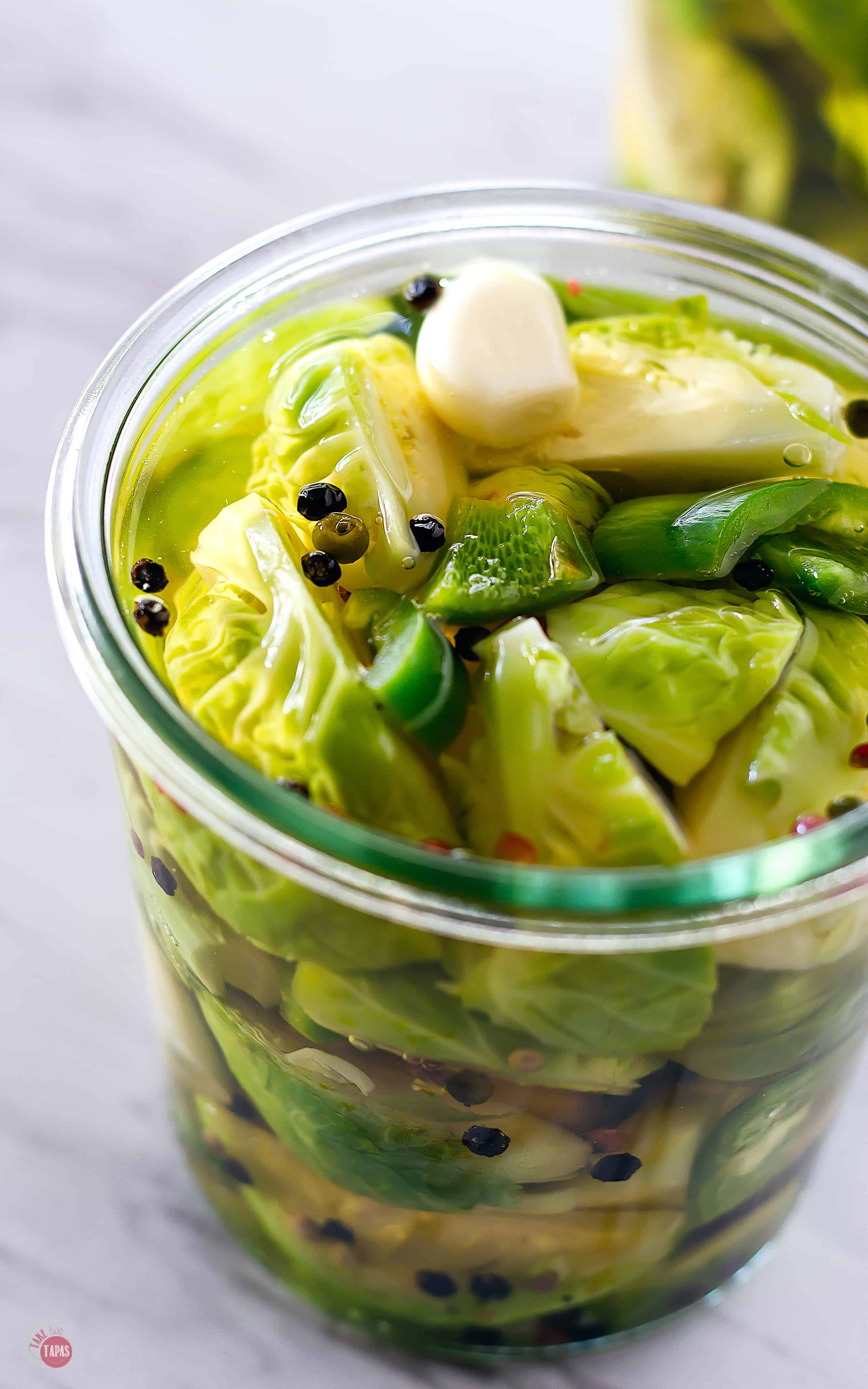 Fill the jar with the pickling liquid to the the top leaving 1/4 inch of space. | Take Two Tapas | Pickled Brussels Sprouts | #PickledBrusselsSprouts #BrusselsSprouts