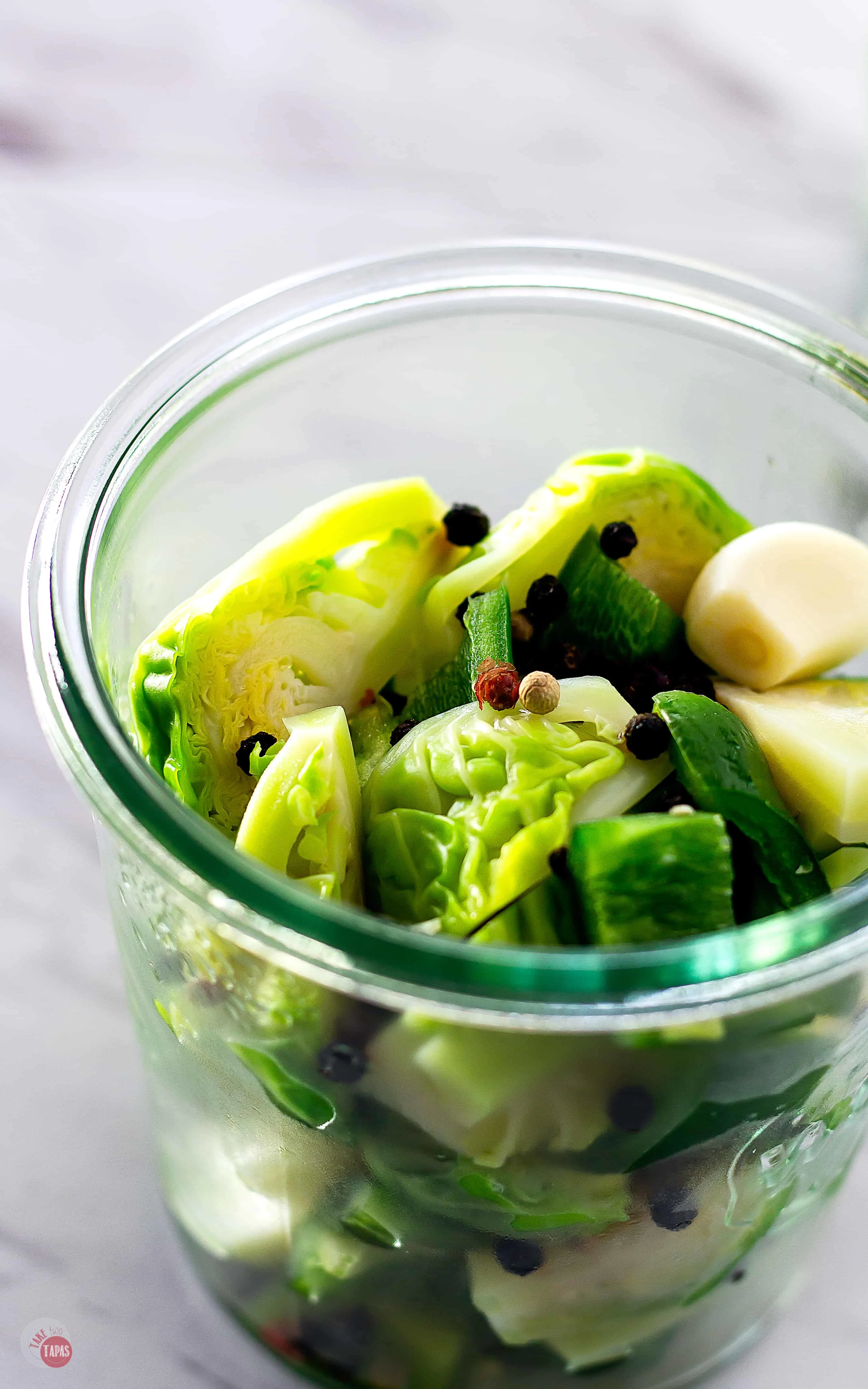 Stuff your jar with the par-boiled sprouts, garlic, spices, and jalapeño peppers before adding liquid. | Take Two Tapas | Pickled Brussels Sprouts | #PickledBrusselsSprouts #BrusselsSprouts