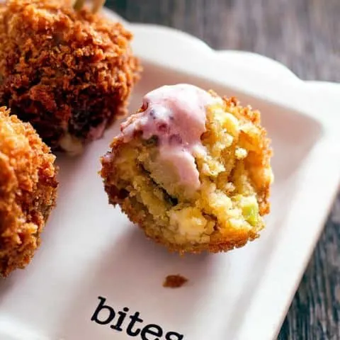 close up of cornbread ball with bite out of it
