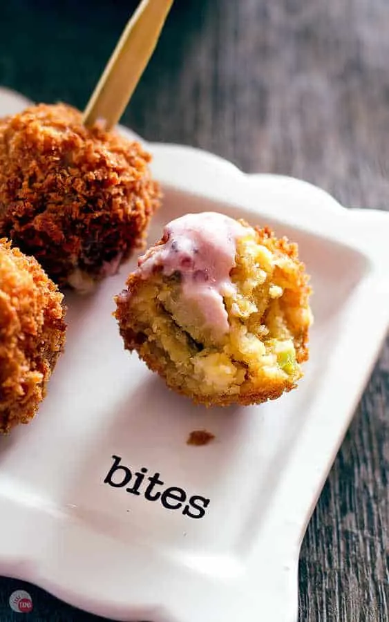 close up of cornbread ball with bite out of it