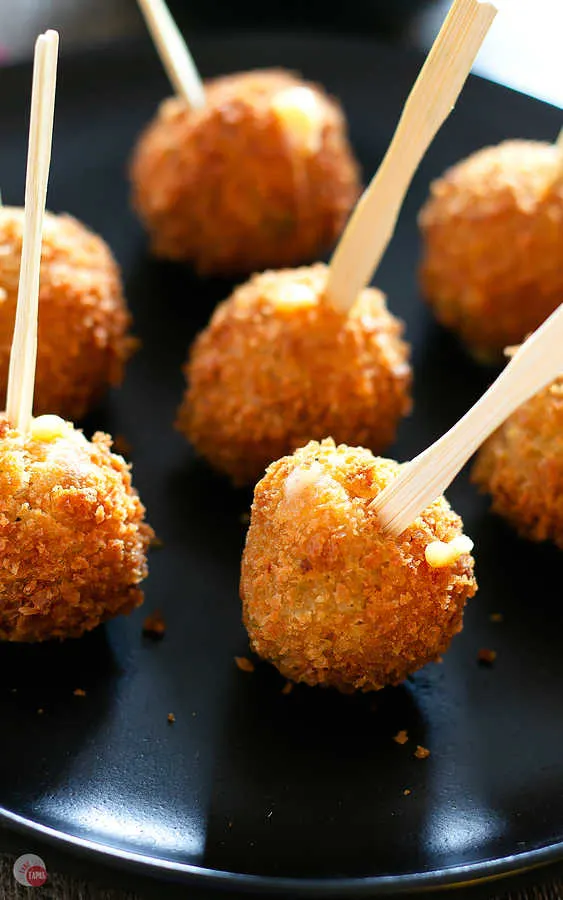 Close up of cornbread balls with skewers in them