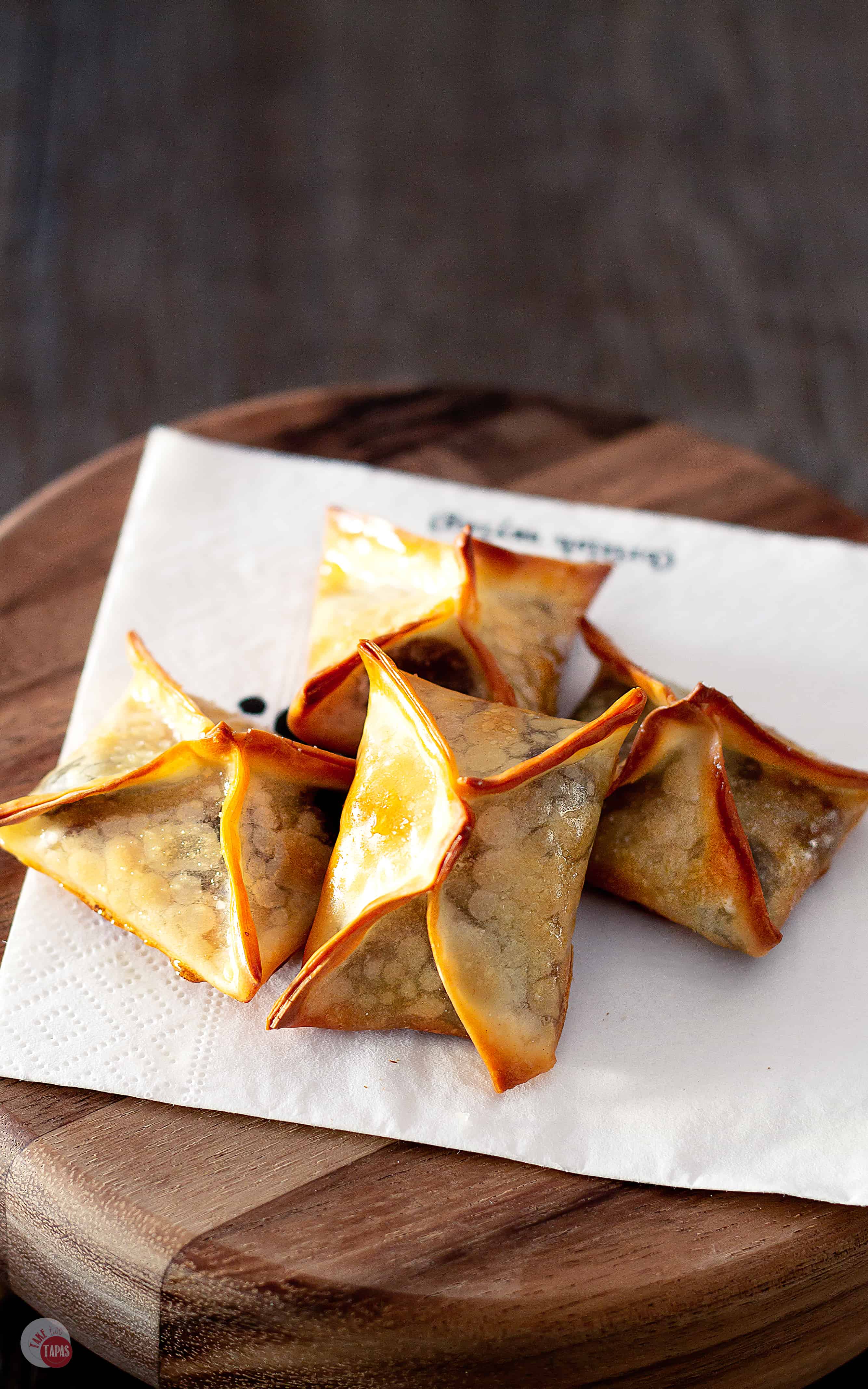 Chocolate Caramel and Pecans all bundled up in wonton wrappers. Turtle Wonton Kisses | Take Two Tapas | #Turtles #WontonCookies