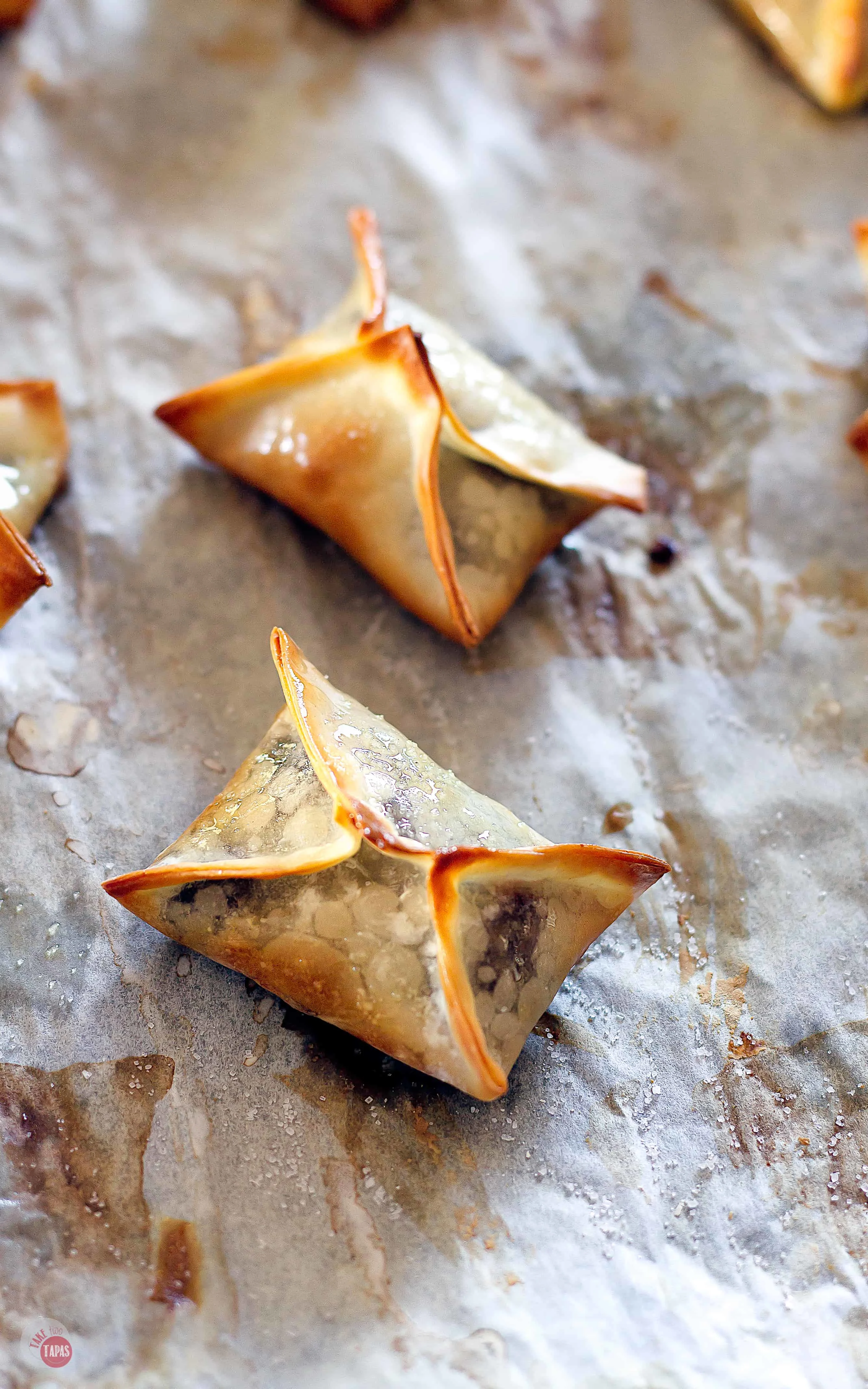 wonton on parchment paper just out of the oven