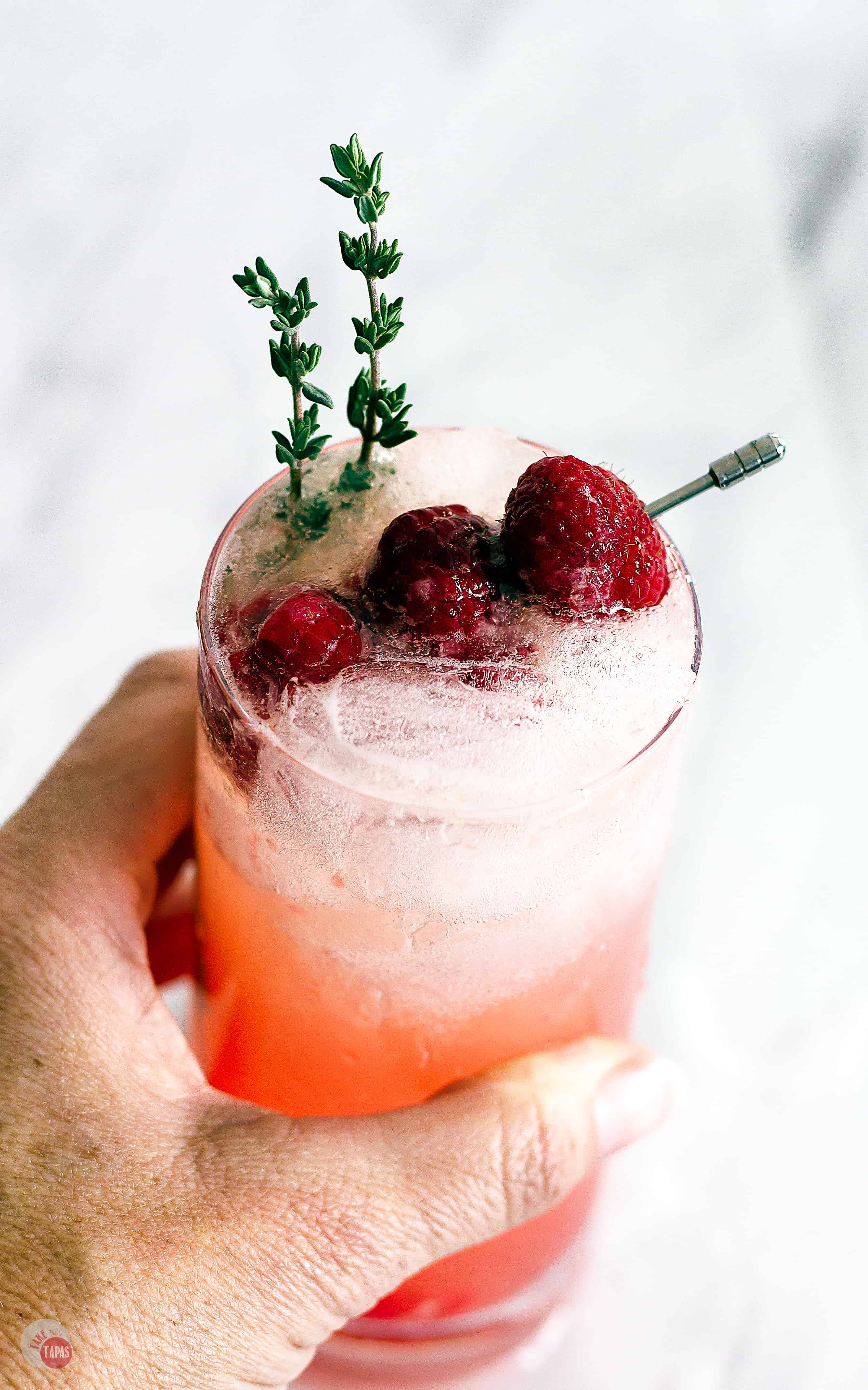 Raspberry Thyme Prosecco Punch can be served as a single cocktail or a large batch punch. | Take Two Tapas | #PunchRecipe #ProseccoCocktail