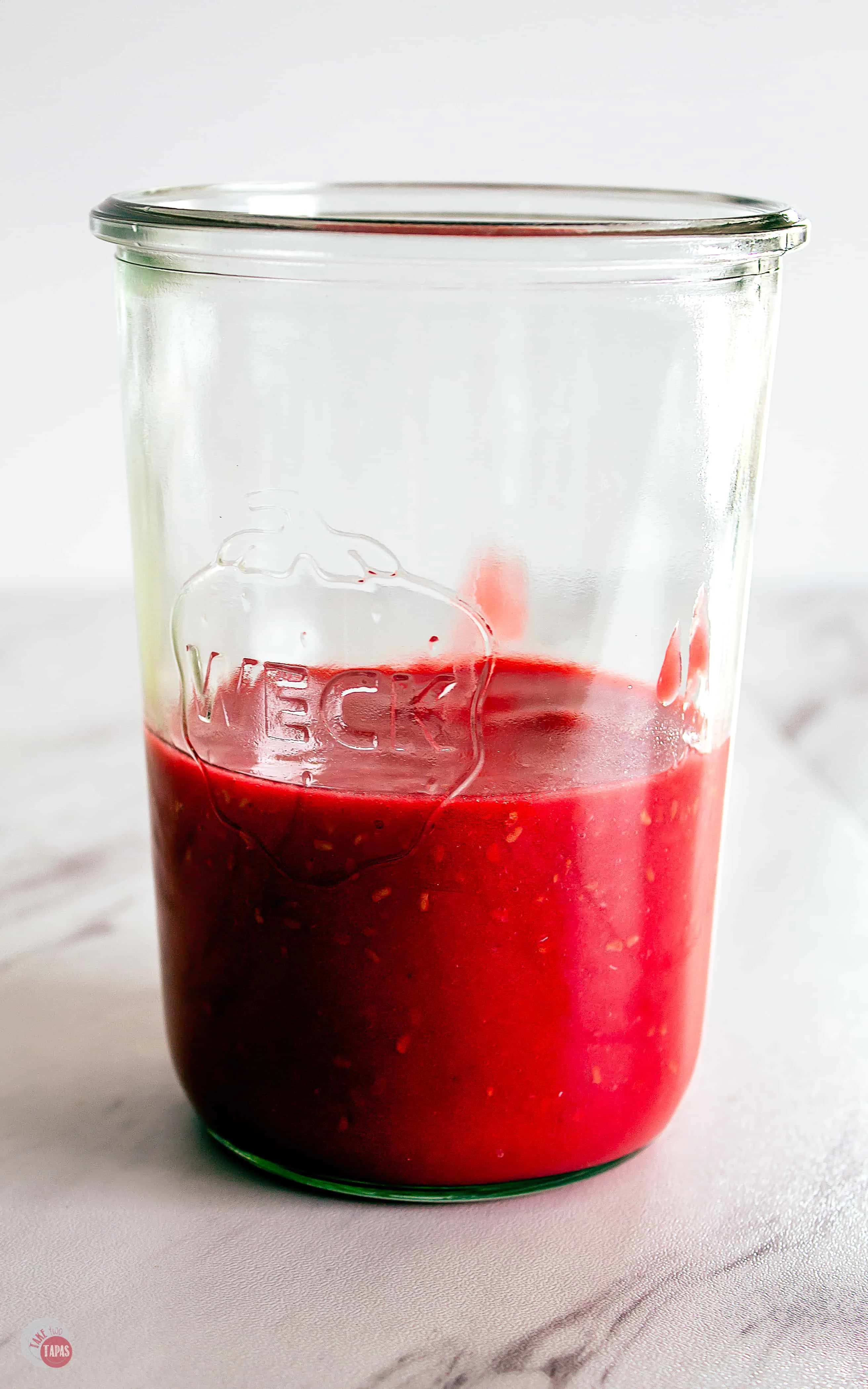 Raspberry Thyme Prosecco Punch starts with homemade raspberry puree! | Take Two Tapas | #PunchRecipe #ProseccoCocktail