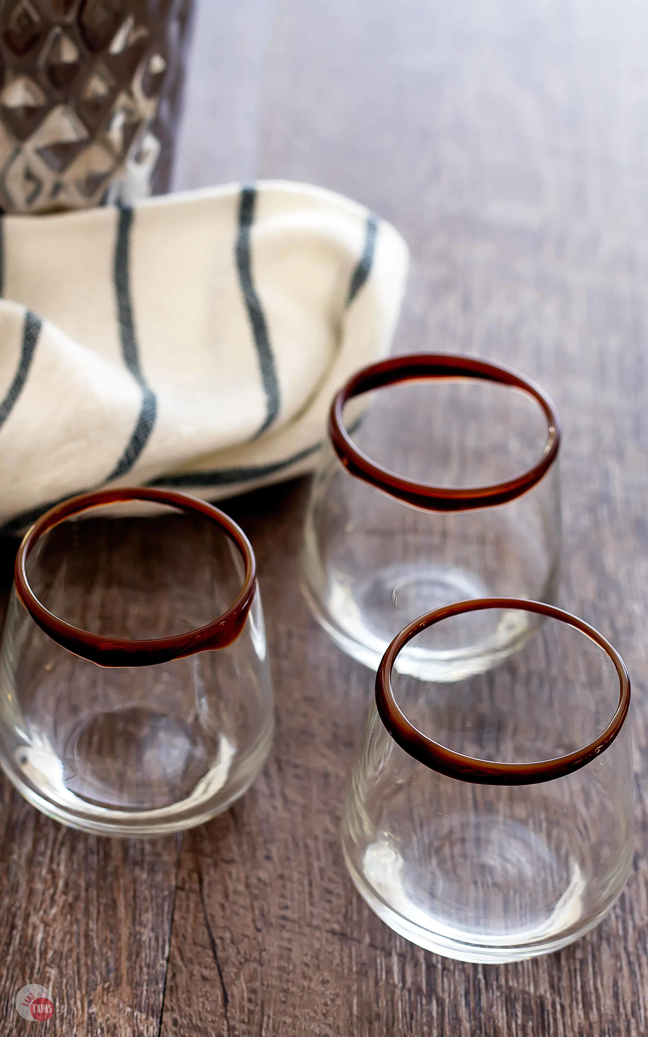 Start your Salted Caramel German Chocolate Cake Shots by putting chocolate syrup on the rim of your shot glass | Take Two Tapas | #CakeShots #DessertCocktails #AD #ChristmasSweetsWeek @ToraniFlavor