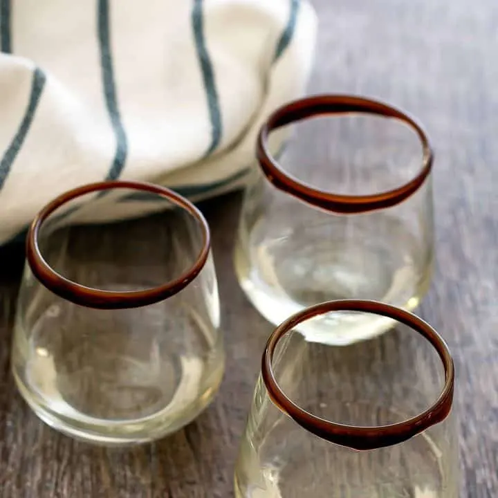 three glasses of shot on a table
