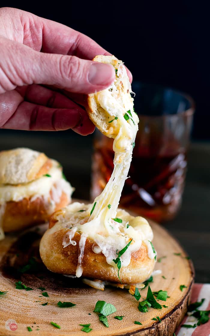 Bread Bowl with top being removed and cheese stretching