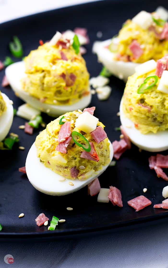 overhead view of muffuletta deviled eggs with salami garnish