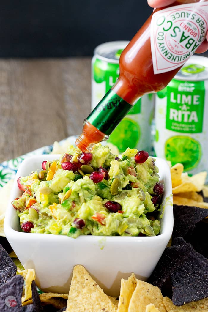 A dash of Tabasco® Sauce gives the perfect amount of heat! Sweet and Spicy Pomegranate Guacamole | Take Two Tapas | #Guacamole #Pomegranate #SavorWinningFlavors #AvocadosFromMexico #HAVEARITA #FlavorYourWorld