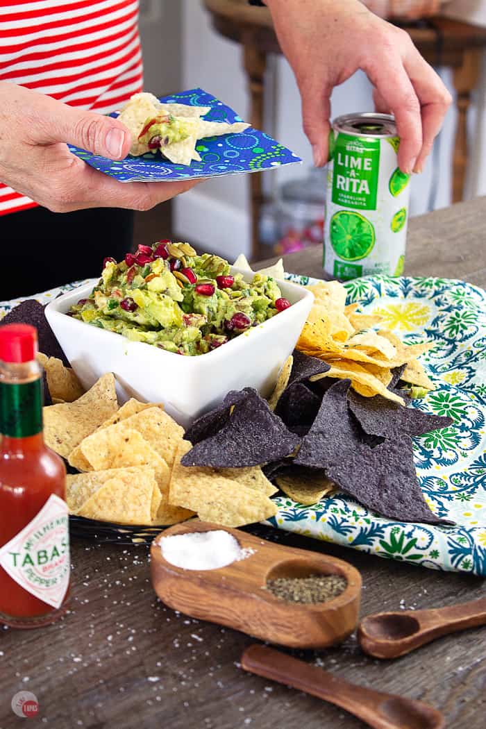 Tart and Spicy Pomegranate Guac is studded with pepitas and pomegranate arils. | Take Two Tapas | #Guacamole #Pomegranate #SavorWinningFlavors #AvocadosFromMexico #HAVEARITA #FlavorYourWorld