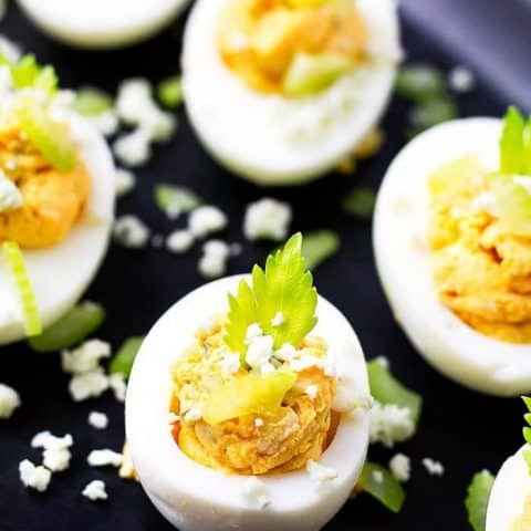 deviled eggs on a black tray