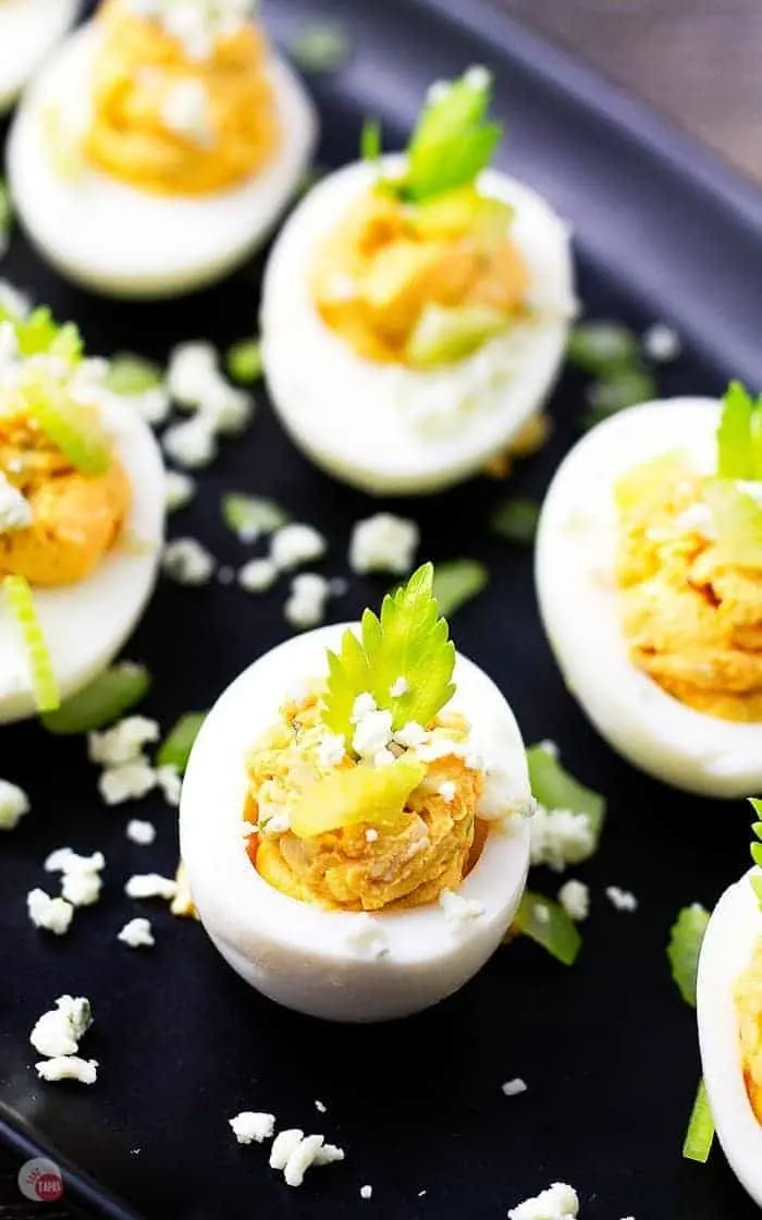 deviled eggs on a black tray