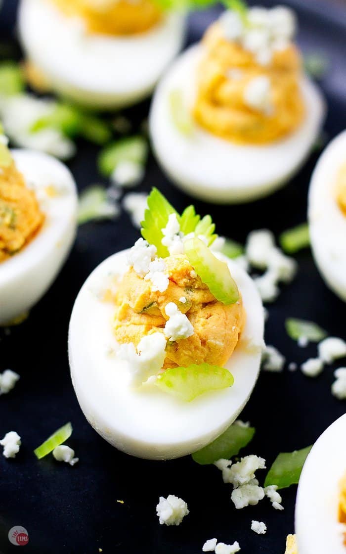sliced celery leaves and crumble blue cheese garnish eggs