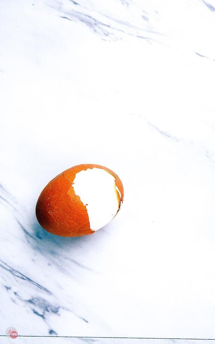 half peeled hard-boiled egg