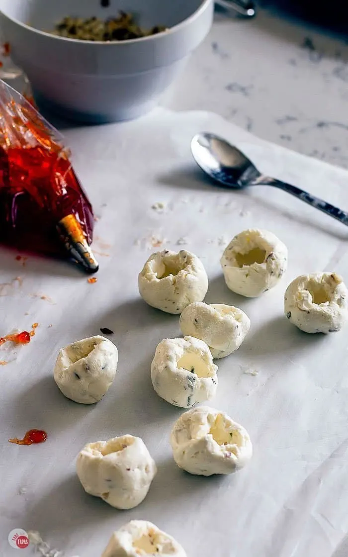 picture of cheese balls with holes and a piping bag of hot pepper jelly