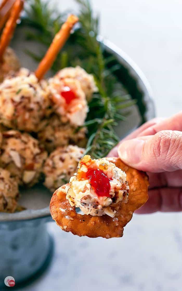 mini hot pepper jelly cheese ball bombs spread on a pretzel cracker