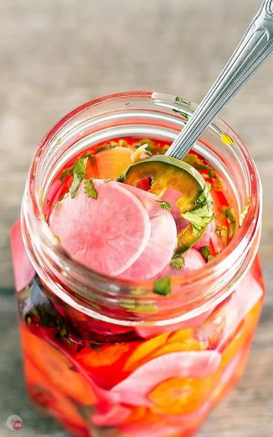 pickles carrots and jalapeños including radishes are taco pickles in a jar