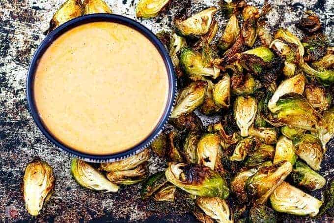 overhead picture of crispy air fryer brussels sprouts with buffalo ranch dipping sauce