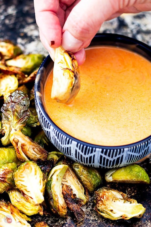 picture of crispy air fryer Brussels sprout dipping in buffalo ranch dipping sauce 