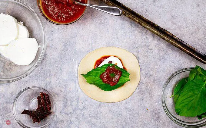 picture of the inside of a caprese empanada before cooking