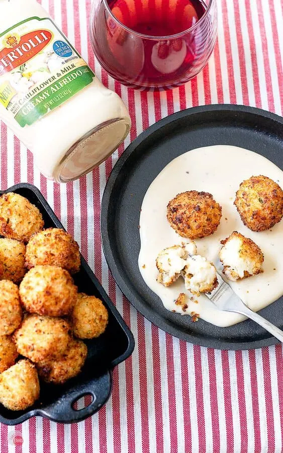 overhead view of cheesy alfredo arancini on a plate