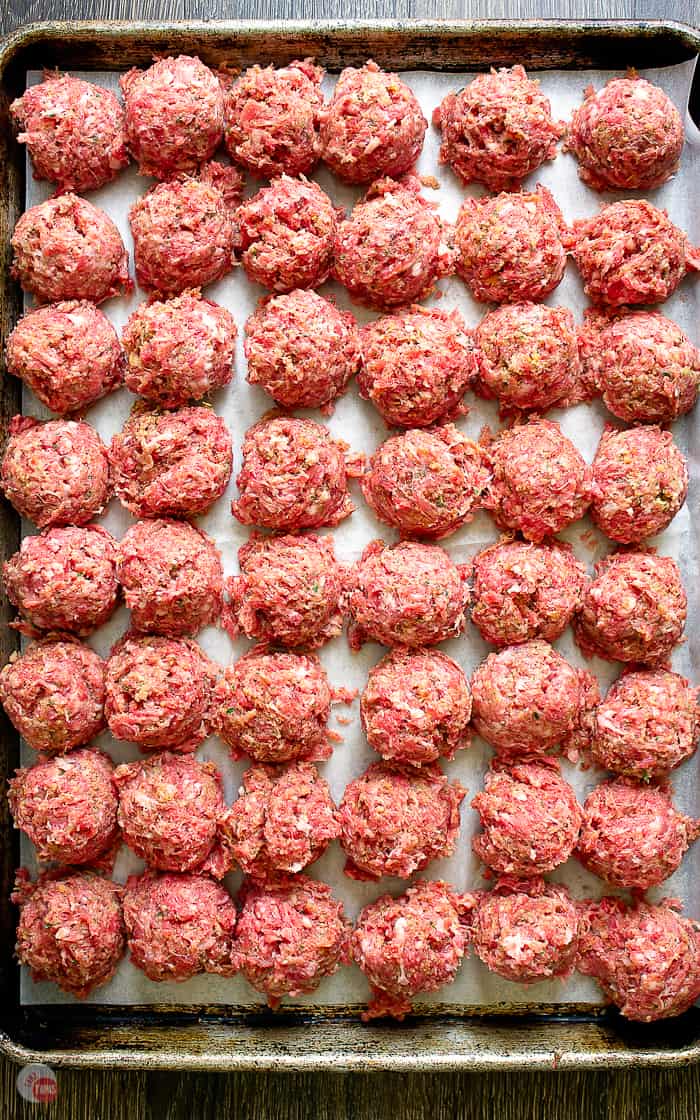uncooked meatballs on a baking tray