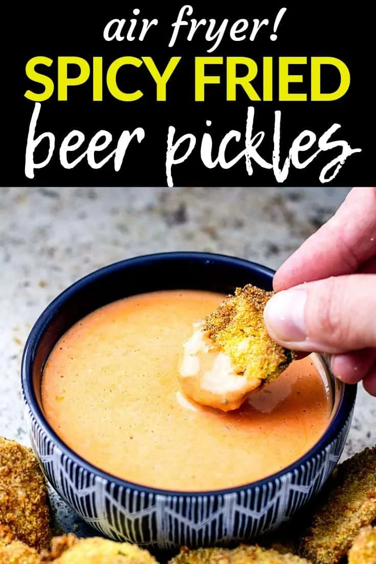 Pinterest image of hand dipping fried pickle in sauce with text "air fryer! spicy fried beer pickles"